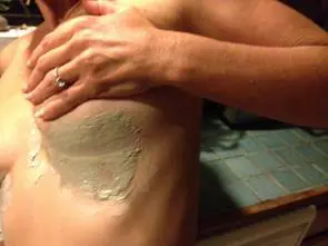 Applying cream on skin with hand.